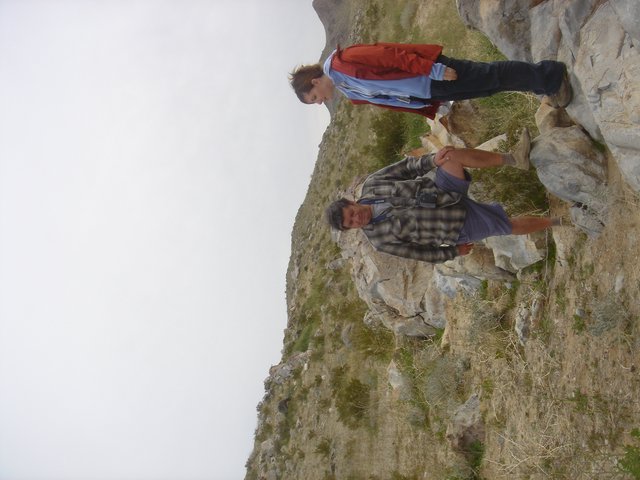 Father and Son Hiking Rocky Hillside Together