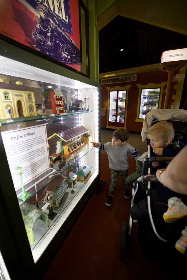 Children Exploring Model Train Display at Museum