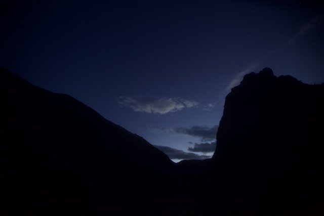 Majestic Mountain Silhouette under Dramatic Night Sky