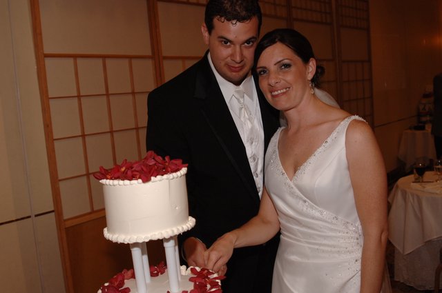 Bride and Groom Cut Wedding Cake Together