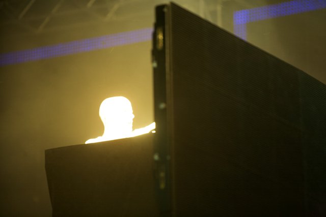 A Silhouetted Figure Against a Mesmerizing LED Screen
