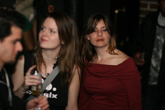 Two Women at a Dimly Lit Nightclub Event