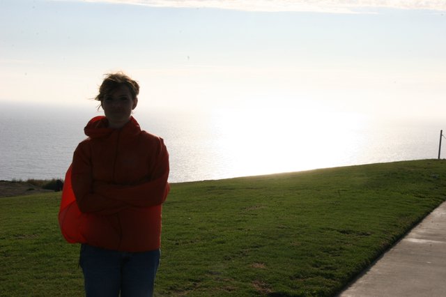 Windswept Woman at Coastal Cliff Overlook