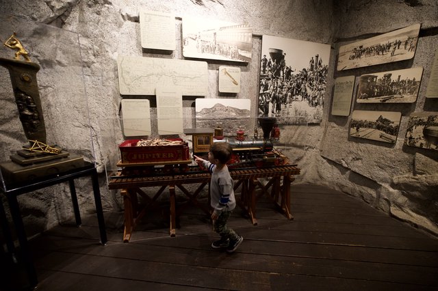 Young Boy Explores Historic Railroad Museum Display