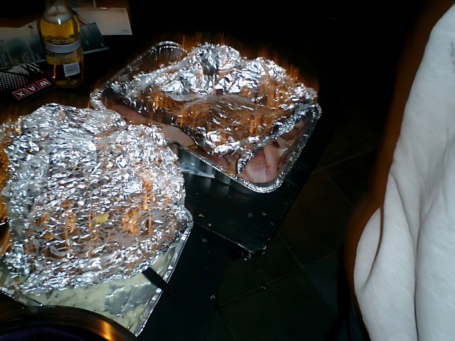 Two Foil Wrapped Trays and a Bottle of Wine
