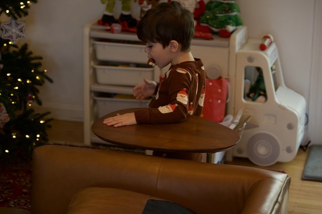 Young Boy in Festive Pajamas at Christmas Play Table