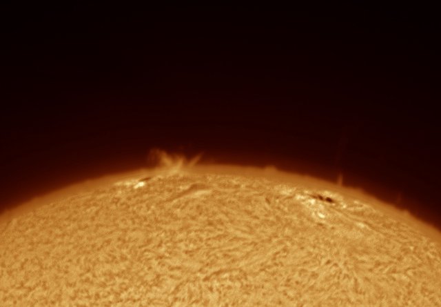 Solar Surge Prominence and Jet Over Sun's Limb