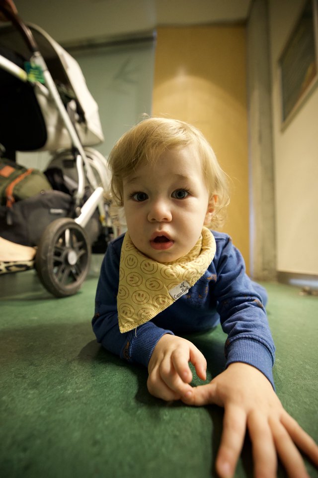 Curious Toddler Crawling on Green Hospital Floor