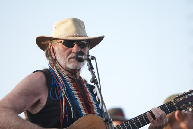 Willie Nelson performs under the blue sky