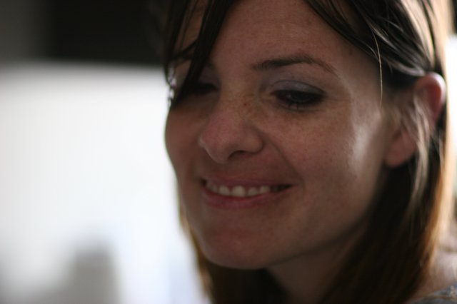 Candid Smile of a Woman in Soft Light