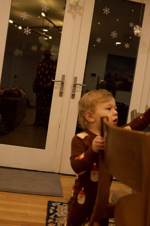 Young Child Opening French Doors on Christmas Day