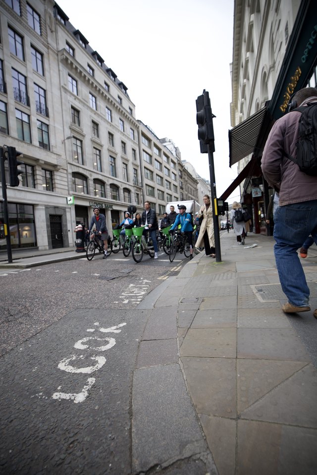 Cyclists on London Street with Classical Architecture