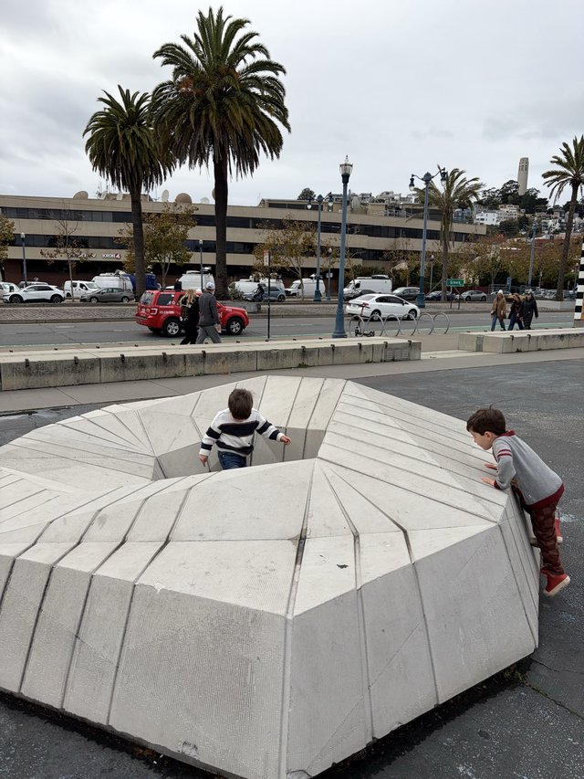 Children Exploring Concrete Amphitheater Steps in Urban Setting