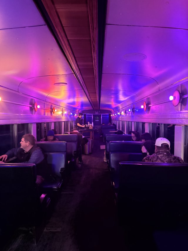 Purple-Lit Train Car Interior with Atmospheric Mood Lighting