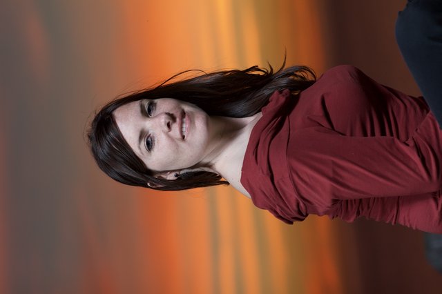 Woman in Red Against a Blazing Sunset Sky