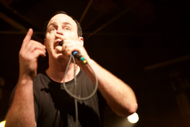 Energetic Man Performing With Two Microphones