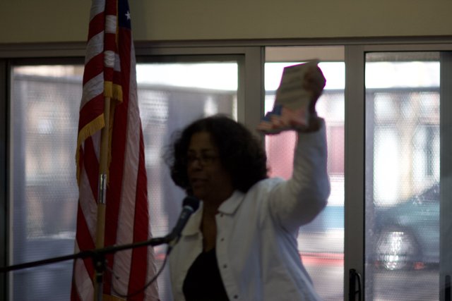 Woman Holding Up Paper with American Flag Motif