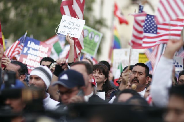American and Mexican Flags Held by Crowd