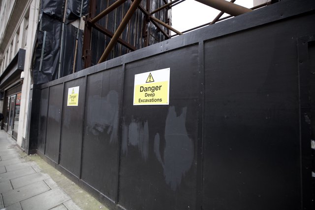 Construction Site Warning Signs on Urban Street Barrier
