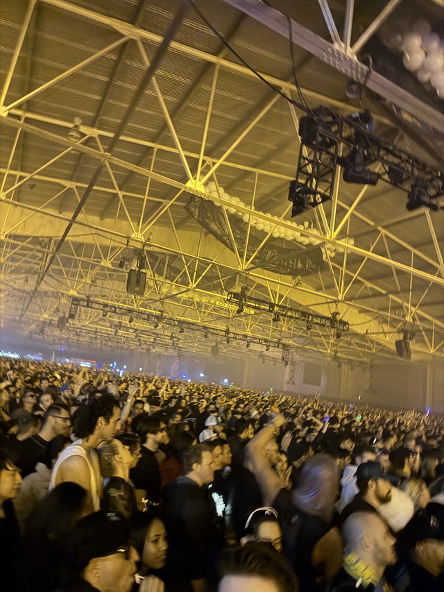Massive Electronic Music Concert with Yellow Stage Lighting