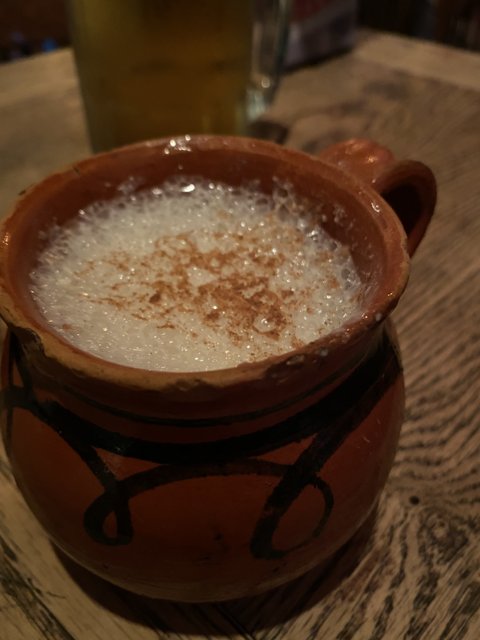 Brown mug and spoon of milk
