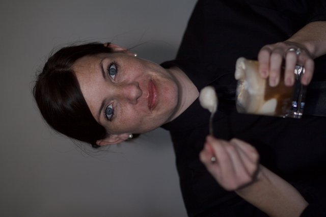 Woman Savoring Dessert with Playful Expression