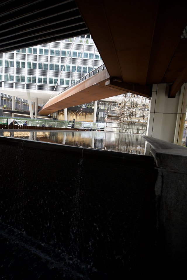 Reflective Pool Under Modern Architectural Canopy in London