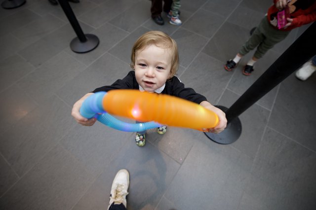 Toddler with Colorful Toy at Baby Rave Event