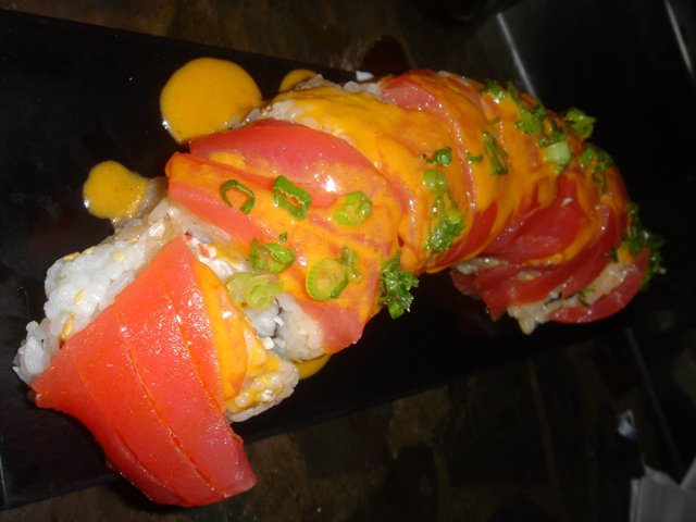 Towering Sushi Roll with Fresh Tomatoes and Green Onions