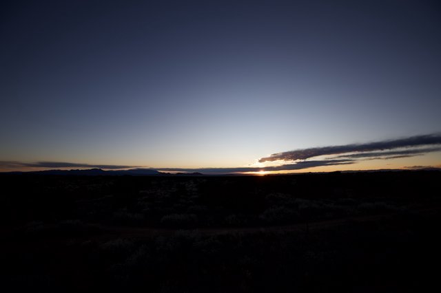 Desert Twilight Over Mountain Silhouettes at Dusk