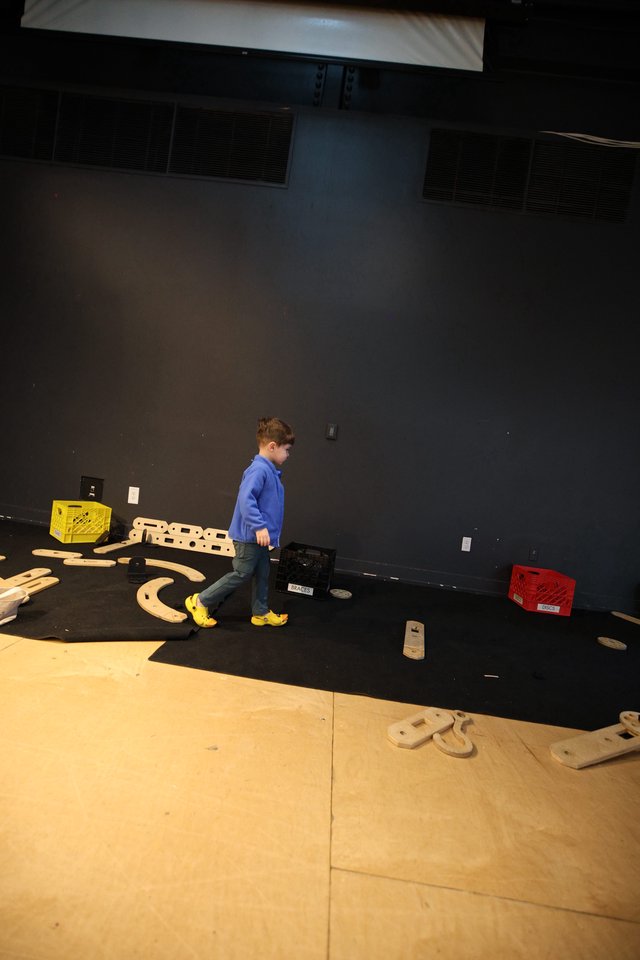 Young Builder on Stage with Wooden Construction Set