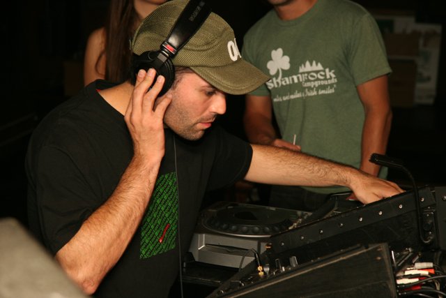DJ in Green Shirt Spinning the Tables