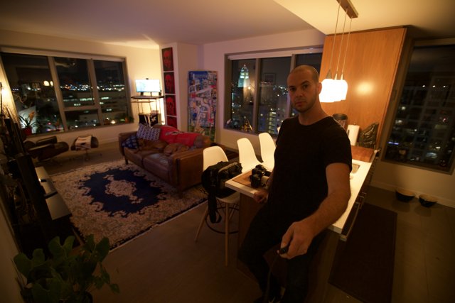 Man enjoying city view in stylish living room