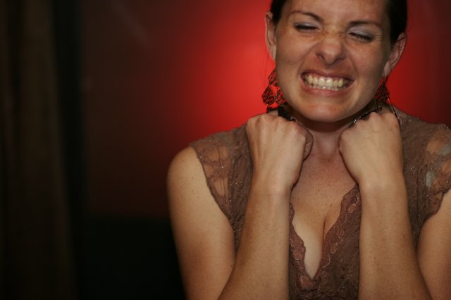 Woman Laughing Joyfully with Fists Raised at Party