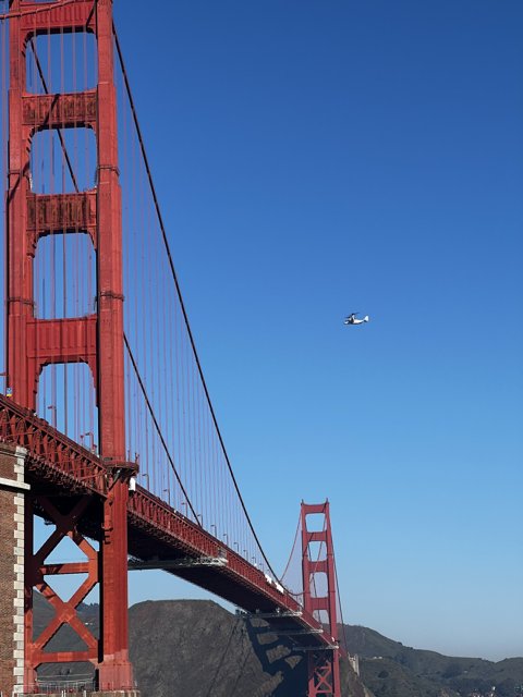 Helicopter hovering over Golden Gate Bridge