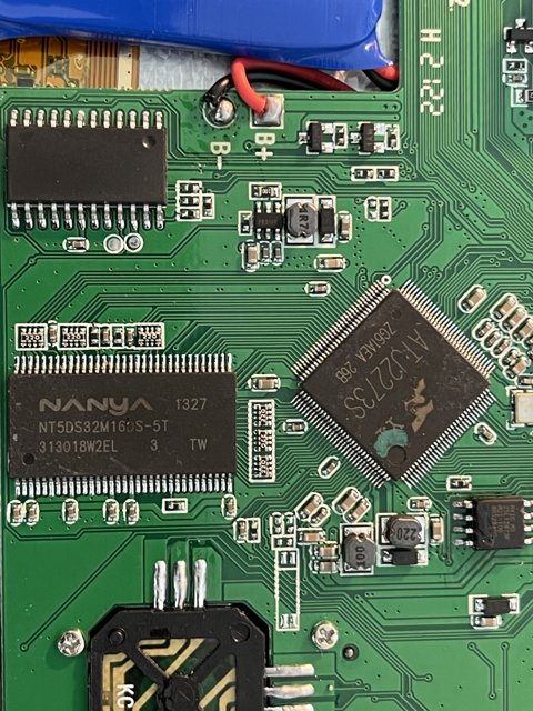 Inside the Machine: A Close-Up of a Motherboard with Battery and Charger