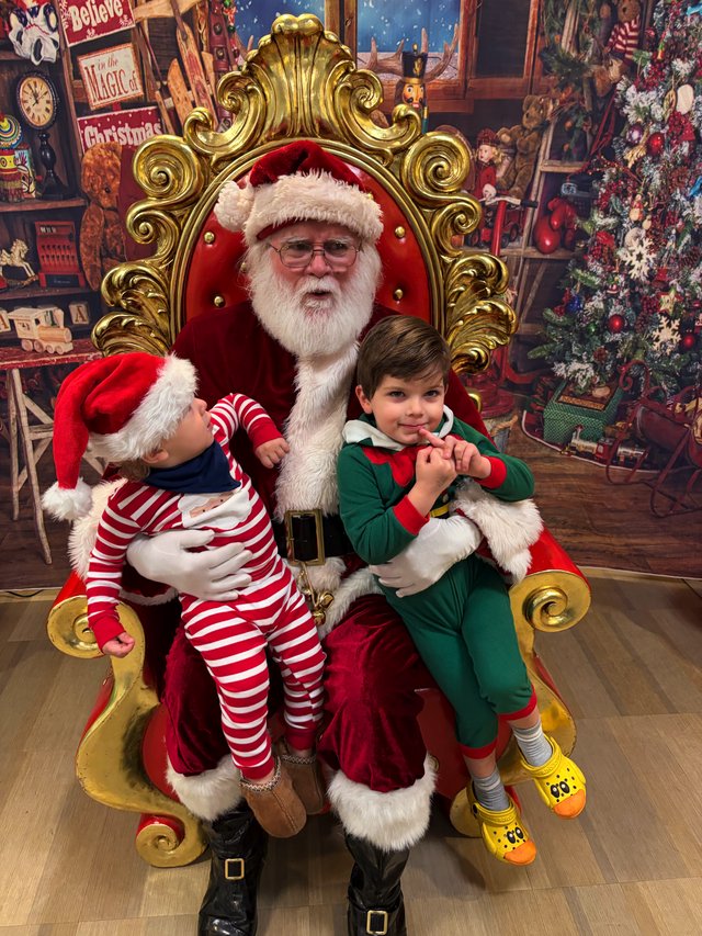 Two Children Visit Santa in His Ornate Golden Throne