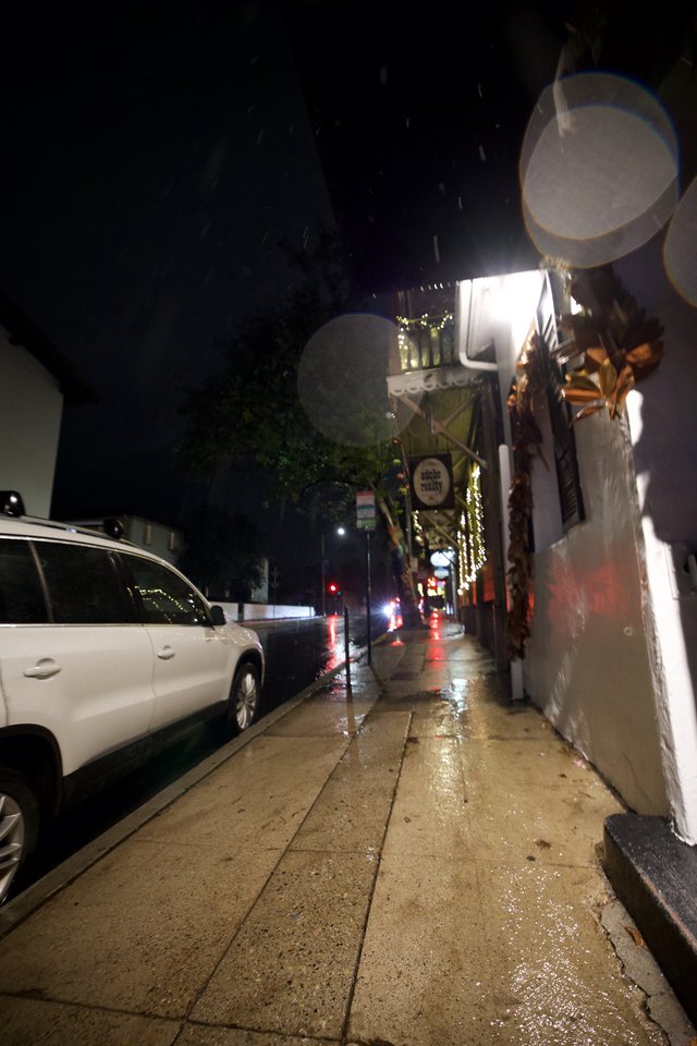Rainy Night on a Quiet Urban Sidewalk