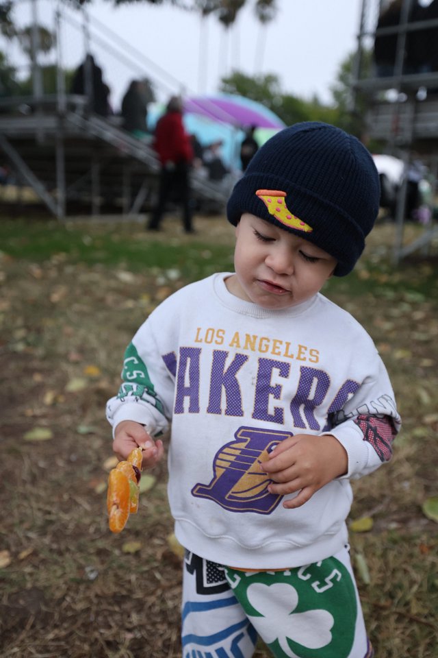 Young Lakers Fan Snacking at Outdoor Festival