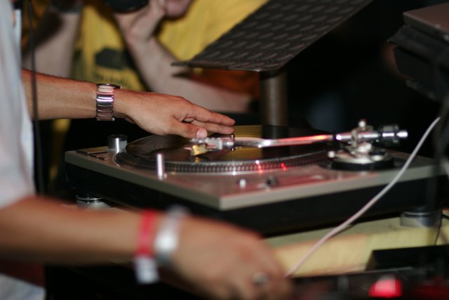 DJ spinning tunes on turntable