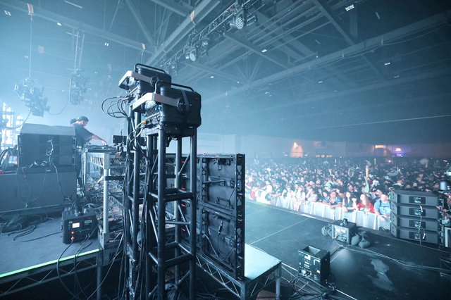 DJ Performs Before Massive Indoor Festival Crowd