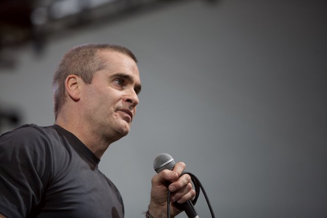 Henry Rollins Takes the Stage with Microphone in Hand