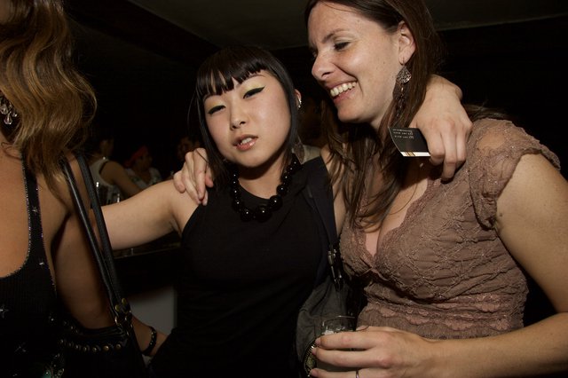 Two Friends Laughing Together at a Nightclub