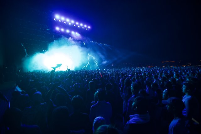 Blue Spotlight on the Rock Concert Crowd