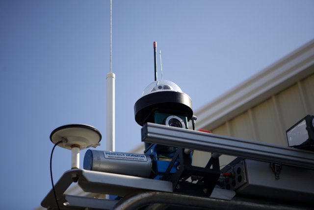 Surveillance Camera in the Clear Blue Sky