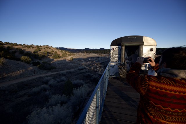 Desert Sunset at Futuristic Observation Platform with Face Sculpture