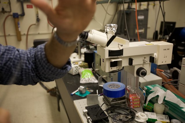 Lab Technician Analyzing Samples Under Microscope