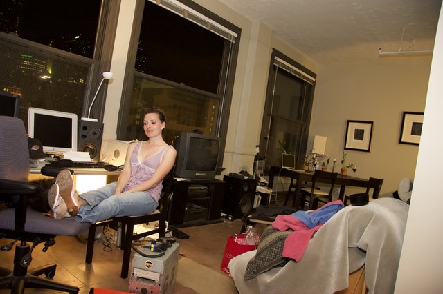 Woman Relaxing in Urban Loft Apartment at Night