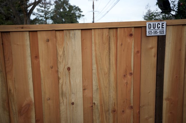New Cedar Fence with Construction Company Sign