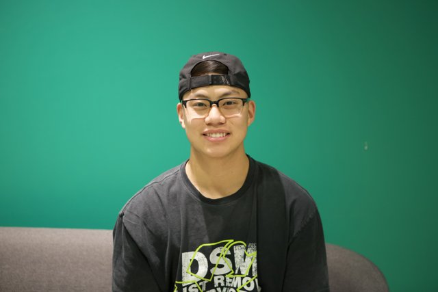 Smiling Teen in Black Hat and Glasses